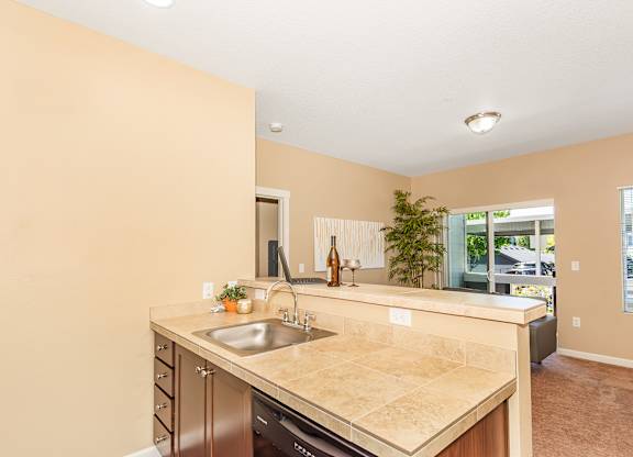 A kitchen with a sink and a counter at The Landing Apartments and Townhomes, Oregon, 97045