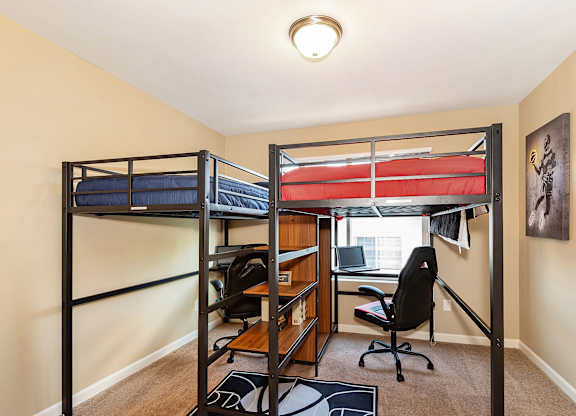 A room with two bunk beds and a desk with a chair at The Landing Apartments and Townhomes, Oregon, 97045