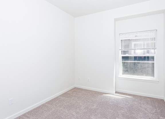 A room with a window and carpeted floor at The Landing Apartments and Townhomes, Oregon, 97045