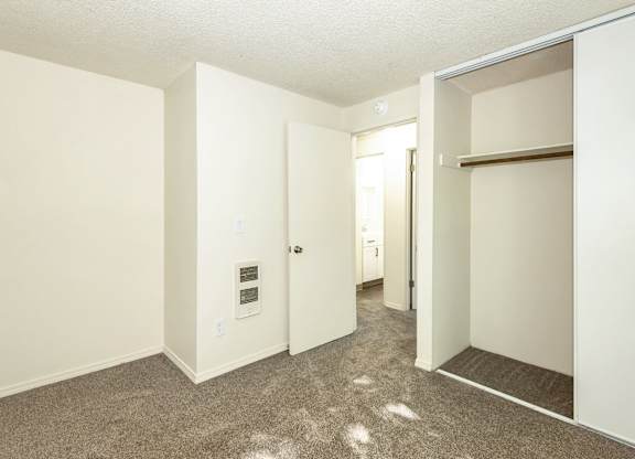 A white door in a room with carpeted flooring at Todd Village Apartments, Oregon, 97062