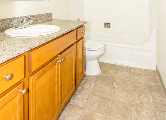 A bathroom with a toilet, sink, and shower at Todd Village Apartments, Oregon, 97062
