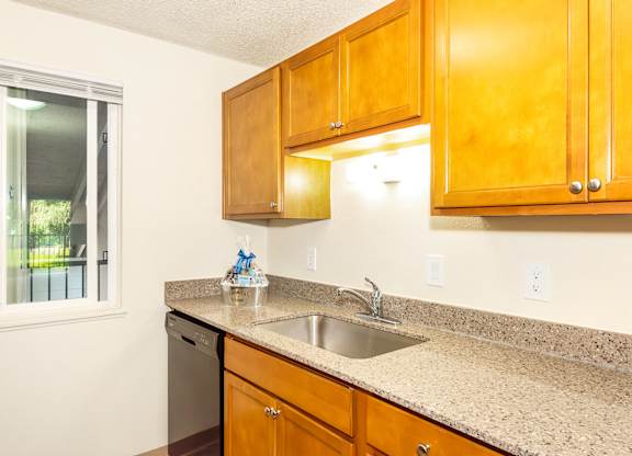 A kitchen with wooden cabinets and countertop at Todd Village Apartments, Oregon, 97062