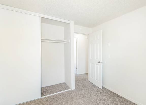 A white door is open to a hallway at Todd Village Apartments, Oregon, 97062