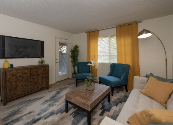 model living room and patio door at Woodbridge Apartments, Sacramento