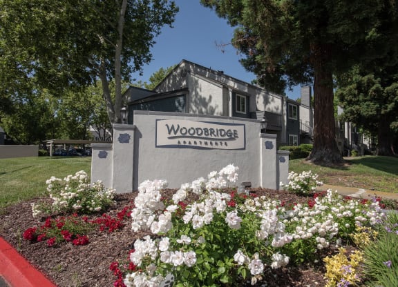 monument sign and flowers at Woodbridge Apartments, Sacramento, California 95833