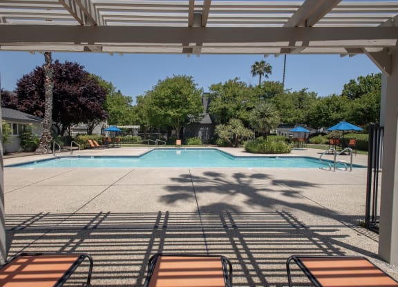 swimming pool arbor and furniture at Woodbridge Apartments, California, 95833