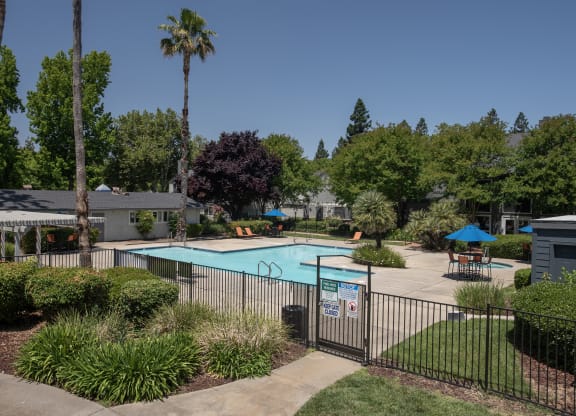 swimming pool fenced exterior at Woodbridge Apartments, Sacramento CA