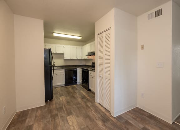 vacant 1x1 dining room to kitchen view at Woodbridge Apartments, Sacramento