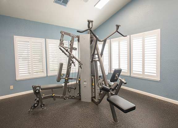 A gym with a blue wall and a white door at Zinfandel Village Apartments, California, 95670
