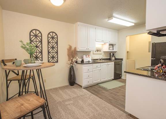 A kitchen with a table and chairs in it at Zinfandel Village Apartments, California, 95670