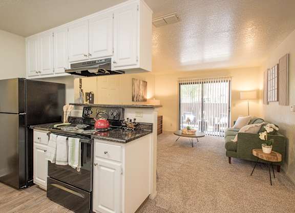 A kitchen with black appliances and white cabinets at Zinfandel Village Apartments, California, 95670