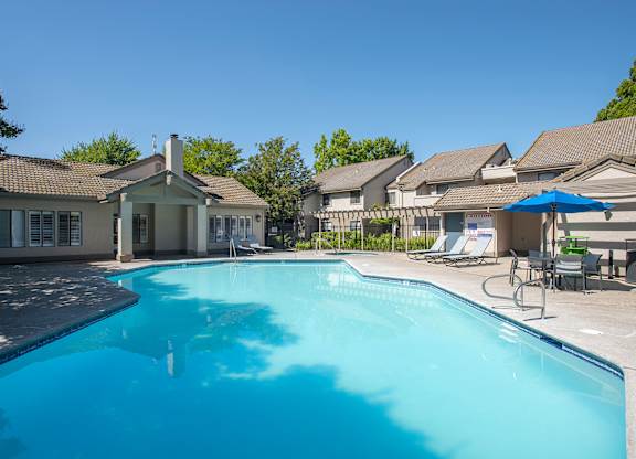 A swimming pool and clubhouse at Zinfandel Village Apartments, California, 95670