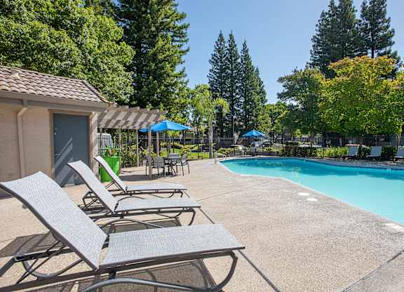 A pool area with sun loungers at Zinfandel Village Apartments, California, 95670