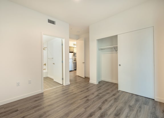 a renovated living room with white walls and wood floors