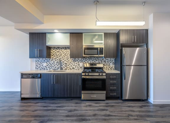 a kitchen with a stainless steel refrigerator and a microwave