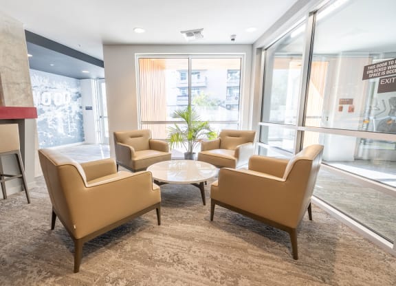 a lounge area with chairs and a coffee table