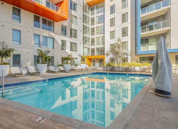 a swimming pool in front of an apartment building