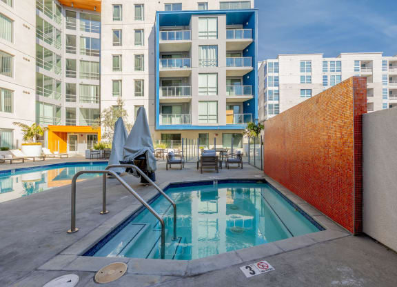 a swimming pool with a building in the background