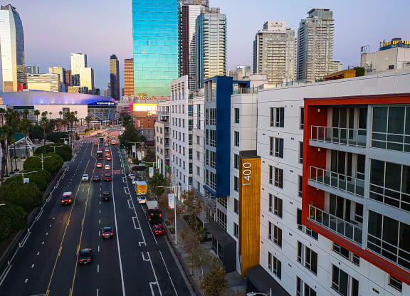 a view of a busy city street with tall buildings