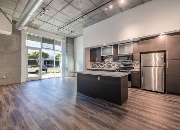 Open kitchen and living/work space in a Live and Work apartment at 1400 FIG Apartments in Los Angeles, California.