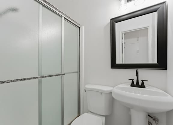 A white toilet sits next to a sink in a bathroom.