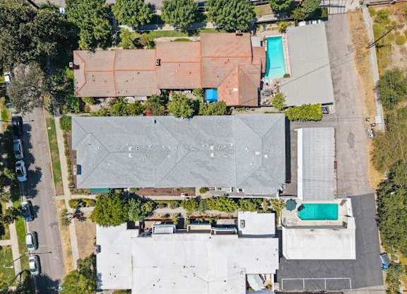 A large grey building with a pool in the middle of it.