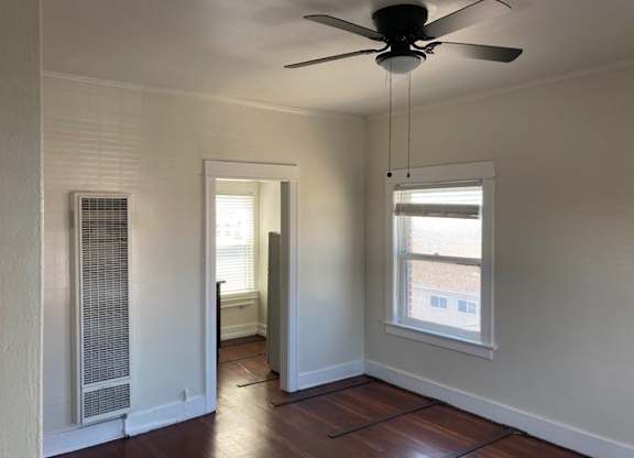 Studio apartment with beautiful hardwood floors, ceiling fan, and great natural light at The Western at Rosewood Apartments in Los Angeles, California.