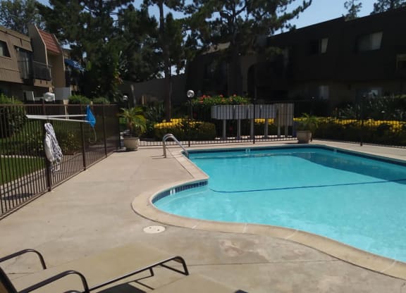 Swimming pool with beautiful surroundings at Teton Pines Apartments in Escondido, California.
