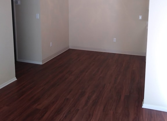 Dining room with ceiling fan and dark hardwood flooring at Teton Pines Apartments in Escondido, California.