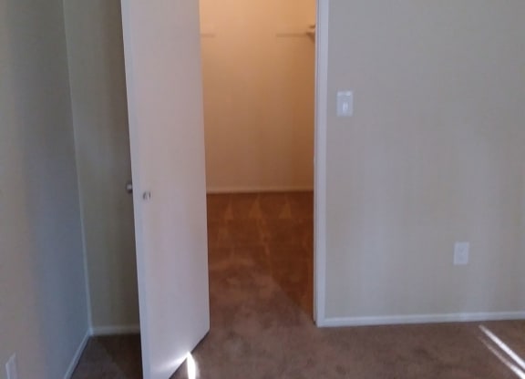 Betroom with large walk-in closet at Teton Pines Apartments in Esoncdido, California.