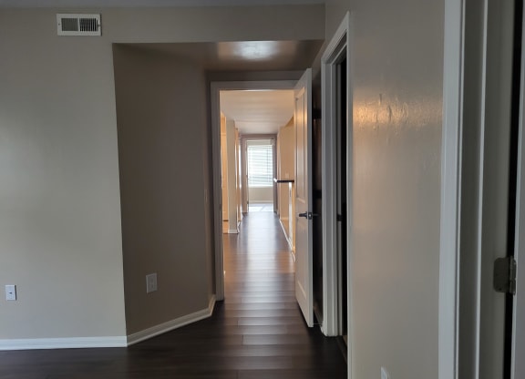 Master bedroom view down hallway to kitchen/living room area and on to bedroom hallway at The Cove at Bear Valley in Escondido, California.