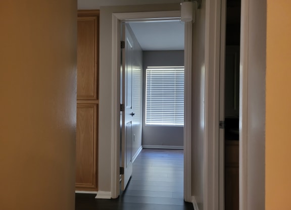 Bedroom hallway with built in cabinets and plank style flooring at The Cove at Bear Valley in Escondido, California.