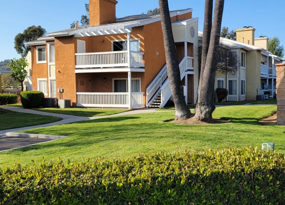 Sidewalk view of luxury apartments at The Cove at Bear Valley in Escondido, California.