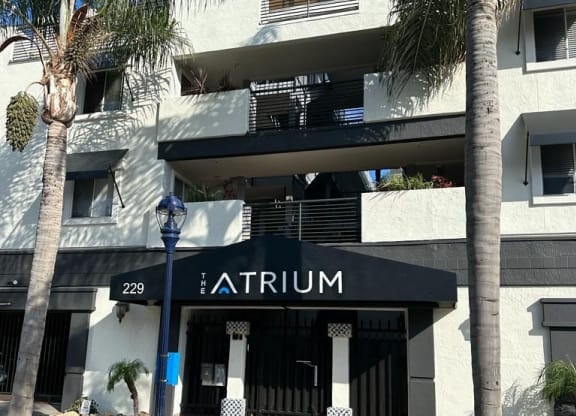 Sidewalk view of front enterance at the Atrium Apartments in downtown San Diego, CA.