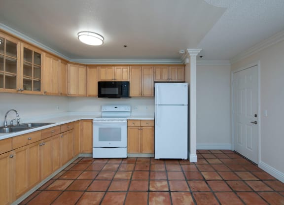 Kitchen with lots of cabinet space and built in appliances at the Atrium Apartments in San Diego, California.
