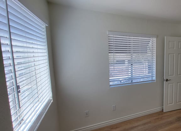 Bedroom with lots of natural light and large closets in one bedroom apartment at the Atrium Apartments in San Diego.