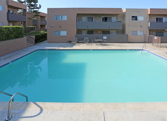 Swimming pool and sun deck at Villa Pacific Apartments in Oceanside, California.