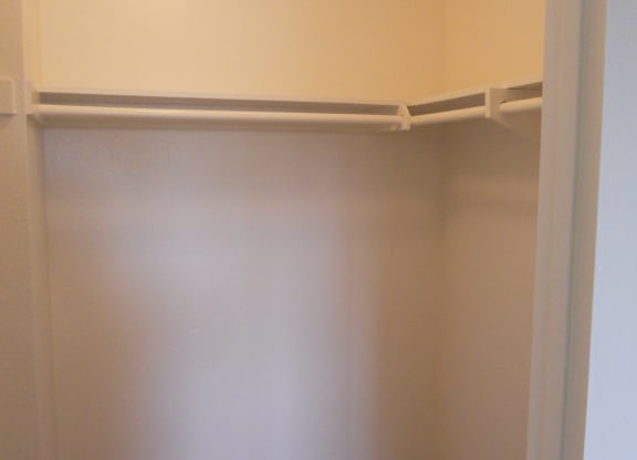 Walk-in closet in carpeted bedroom at Villa Pacific Apartments in Oceanside, California.