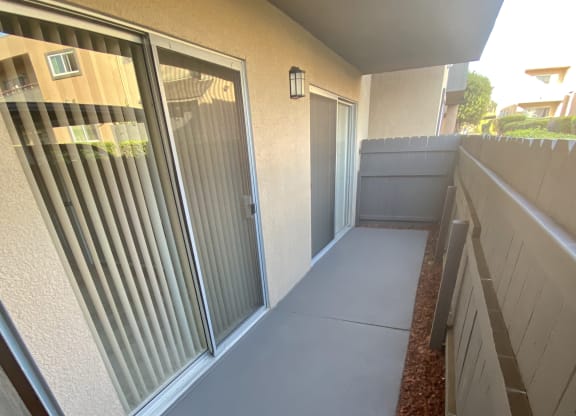 Private porch with access from master bedroom and living room at Villa Pacific Apartments in Oceanside, California.