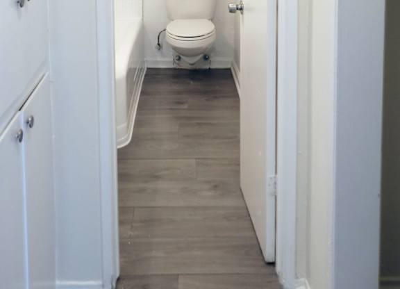A white bathroom with a toilet and a shower.