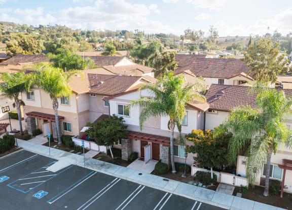Arial view of parking lot and several units at The Nines Townhomes in Escondido, California.