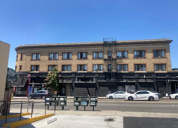 Street view of the brick building with studio apartments at The Western at Rosewood in Los Angeles, California.