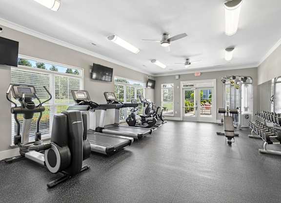 A spacious gym with treadmills, elliptical machines, and other exercise equipment.
