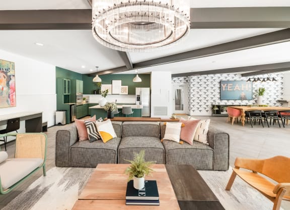 a living room filled with furniture and a large chandelier