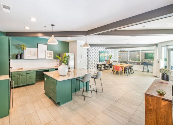 a kitchen with green cabinets and a white counter top