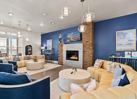 A living room with a fireplace and a yellow couch.