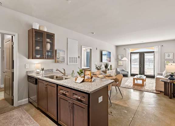 A modern kitchen with a large island and a dining area.