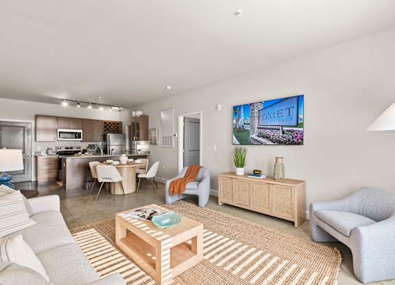 A living room with a sofa, armchair, and coffee table.
