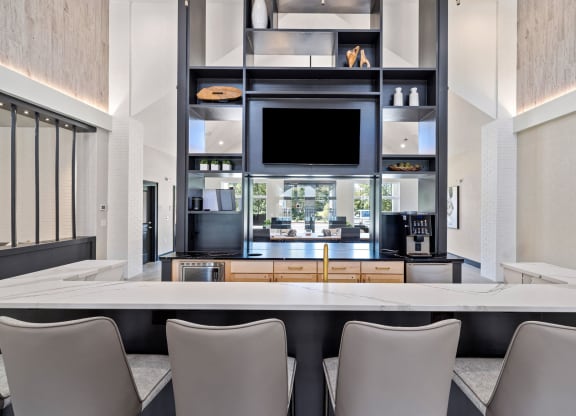 a kitchen with a table and chairs and a television
