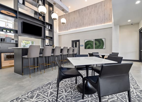 a dining room with a long table and chairs